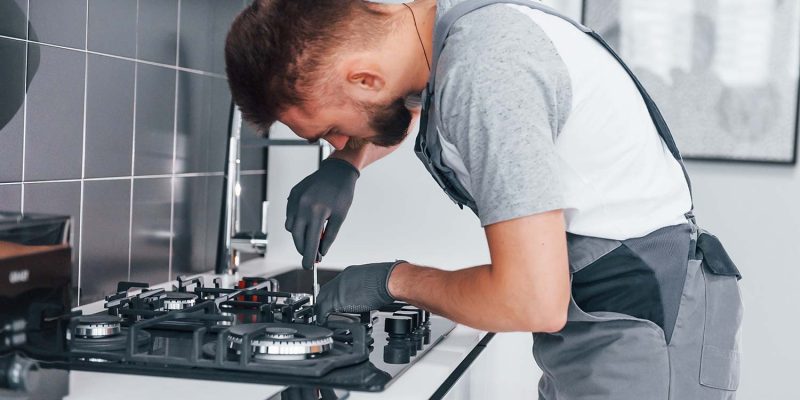 young-professional-plumber-in-grey-uniform-working-resize.jpg